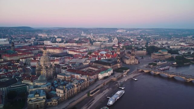 A pushing back aerial shoot of the Frauenkirche with Dresden's Old Town  behind in Dresden in Germany at dawn