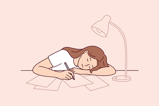 Tired girl falls asleep at her workspace while preparing for university exams and final tests. Concept of education burnout, academic pressure, and the need for rest during intense study periods.
