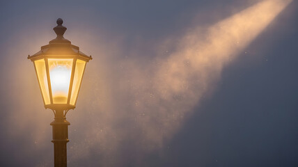 Glowing Vintage Street Lamp Illuminates Misty Night with Atmospheric Light Beam
