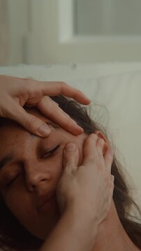 Forehead sinus release by wellness therapist, woman client