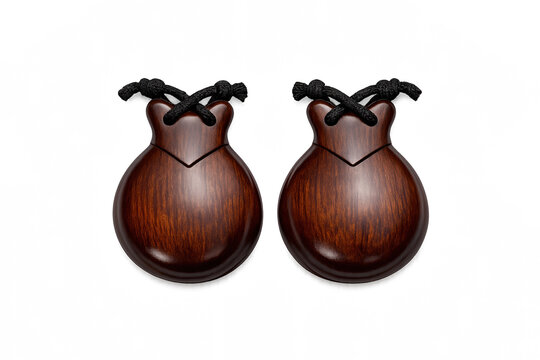 Pair of polished wooden castanets with black strings on a black background