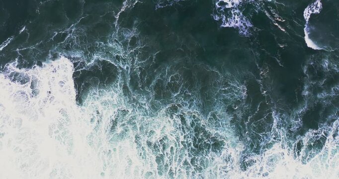 Turbulent sea surface from above at Nazar&eacute;, Portugal in stormy cloudy weather