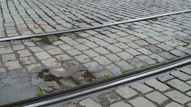 Tram lines run through the old paved street