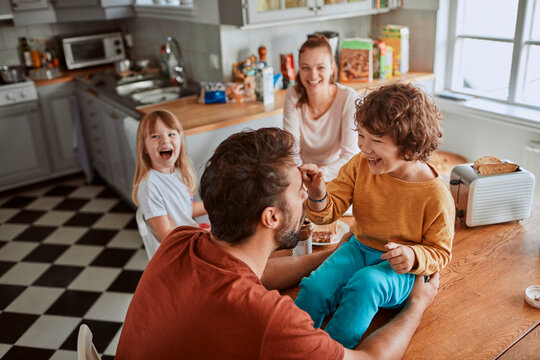 Happy family enjoying breakfast together in a cozy home kitchen