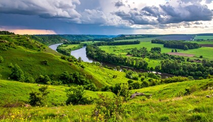 Fototapeta premium Grünes Tal mit Fluss in der Ferne