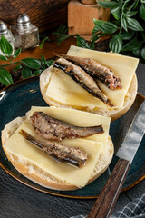 Sandwiches with yellow cheese and sprats.