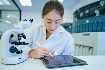 Clinical laboratory scientist recording experimental data into electronic lab notebook (ELN)....