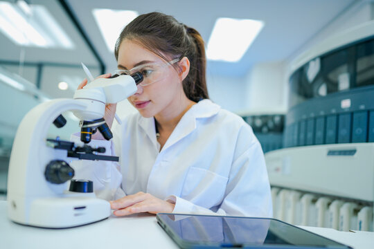 Medical technologist validating automated analyzer results against microscopic observations. Biomedical engineer configuring diagnostic instrument parameters using digital control interface.