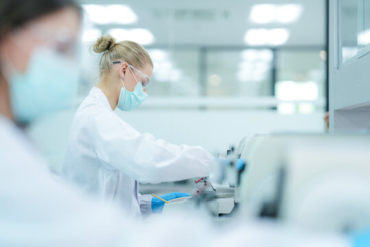 Pharmaceutical quality control analyst validating equipment sterility protocols. R&D chemist monitoring autoclave sterilization cycle for biopharmaceutical compliance.