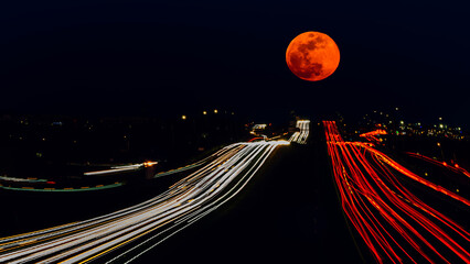 night traffic in the city with moon © Qing Zhao