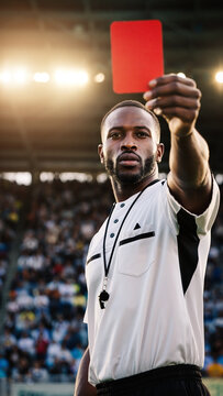Male Soccer Referee Showing Red Card During Football Match at Stadium