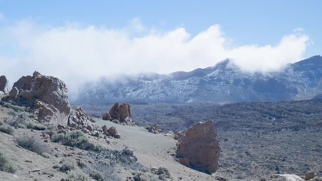 Clouds rolling over a volcanic landscape in teide national park