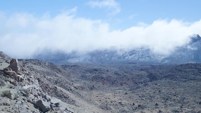 Fast moving clouds covering teide volcano crater