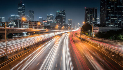 Obraz premium Dynamic long-exposure highway scene at dusk with blurred vehicle light trails, showcasing urban movement and modern city architecture at twilight