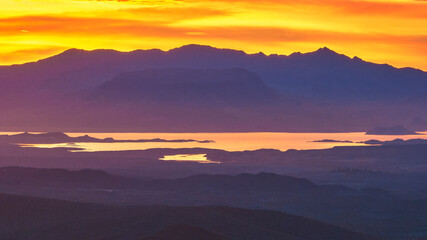 Obraz premium Aerial Sunrise Over Nevada Desert Mountains and Reflective Water Golden Hour