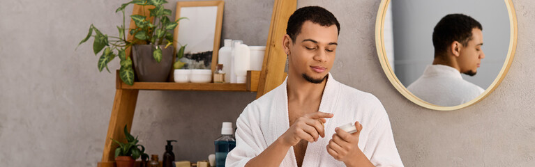 Young handsome man enjoying a relaxing moment at home while applying skincare