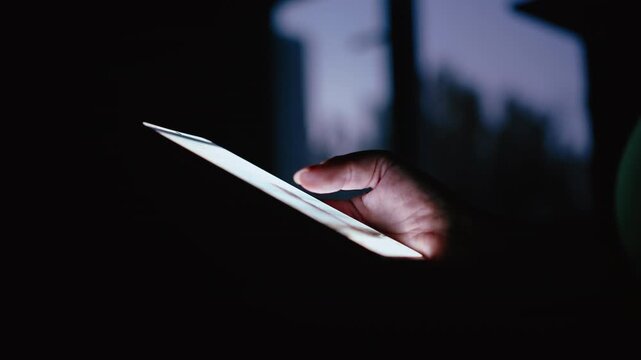 Close-Up Shot of Woman Using Mobile Phone Indoors Near Window in Dark Evening