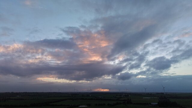 Sunset Over Wind Farm in Irish Countryside with Dramatic Sky