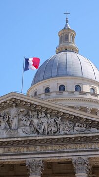 Classic architecture of the Pantheon in Paris with detailed sculptures and French flag above the dome. Iconic landmark image ideal for travel, culture, history and European tourism concepts