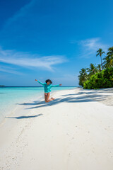 Obraz premium Woman jumping at the beach. Beautiful Panorama, Tropical island beach landscape exotic shore coast. Summer vacation, holiday amazing nature. Relax paradise, Maldives.