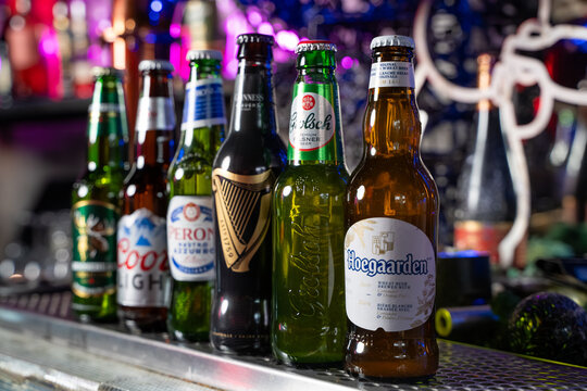 Close up of assorted beer bottles on bar counter. Toronto, Canada - February 20, 2026.