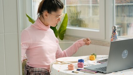 Female with yarn arranging colors while enjoying sunny balcony view