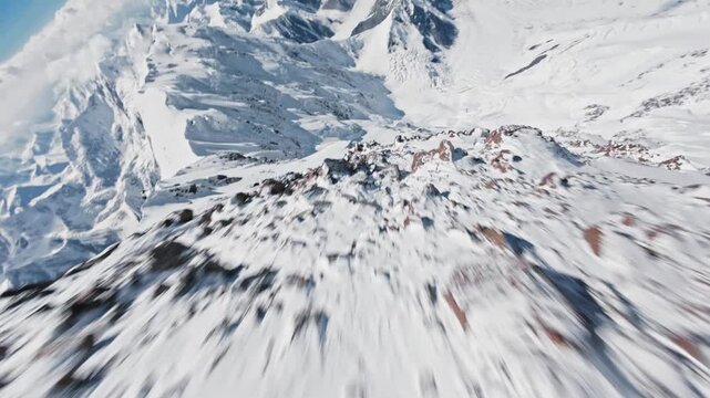 FPV drone dive of the Pobeda Peak slopes, Obelisk Rock, and Camel Hill. Kyrgyzstan, Tien Shan Mountains. 4K