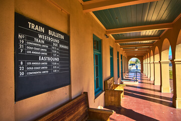 Fototapeta premium Kelso Visitors Center Train Bulletin Board and Sunlit Arched Walkway Mojave