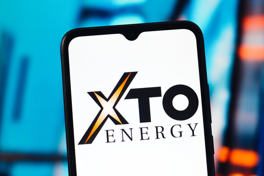 In this photo illustration, the XTO Energy logo is seen displayed on a smartphone screen.