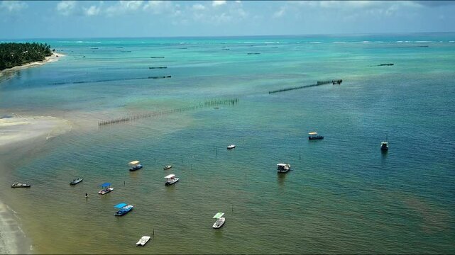 Fishing boats anchored on the idyllic beach in Alagoas in northeastern Brazil.