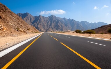 Scenic Highway with Mountain Backdrop Under Clear Blue Sky