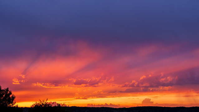 Dramatic Sunset Sky with Vibrant God Rays and Purple Clouds
