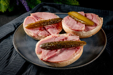 Tasty sandwich with brawn and pickled cucumber.