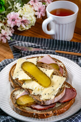 Sandwich with ham, cheese and pickled cucumber.