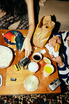 High angle view of man and woman enjoying fast food at home