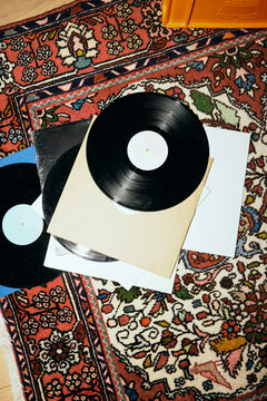 High angle view of old vinyl records on patterned carpet at home