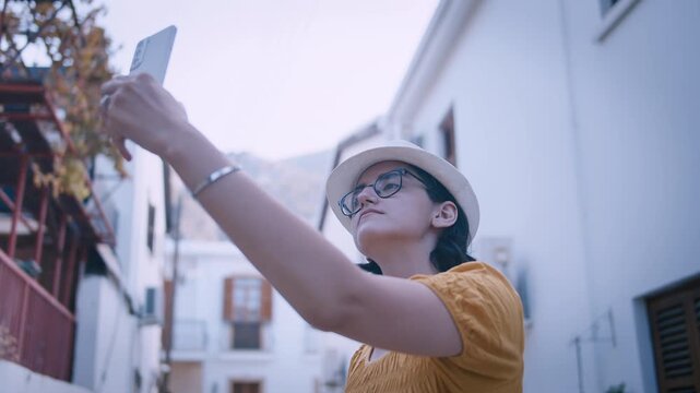 Happy Young Female Traveler Taking Selfie on Beautiful European Street with Cultural Atmosphere