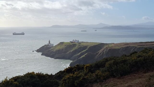 Howth, Ireland - 02 22 2026: Baily Lighthouse from Howth Cliff Walk, an Irish Coastal View
