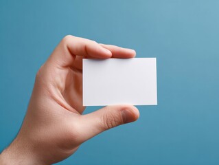 Fototapeta premium person holding business card isolated on a blue background