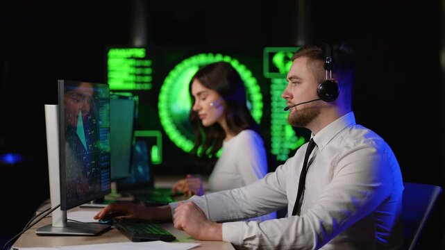Call center operators working in a control room