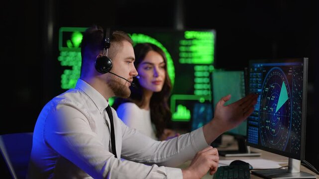 Air traffic controllers monitoring radar in control room