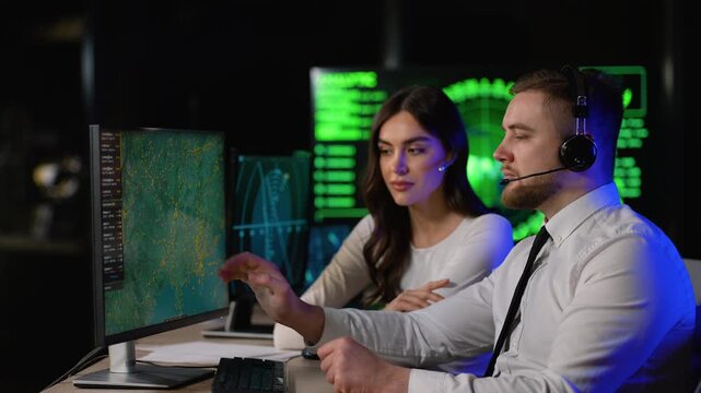 Air traffic controllers monitoring flight paths in a control center