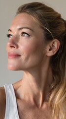 Fototapeta premium Mature woman maintaining healthy skin while aging gracefully, looking away with a genuine smile and confident expression, embracing natural beauty and self care practices