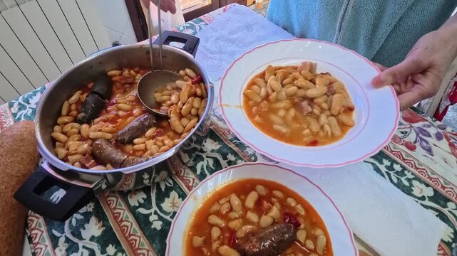 Serving delicious homemade fabada asturiana bean stew