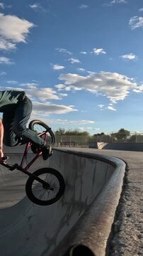 BMX rider trick on skatepark quarterpipe