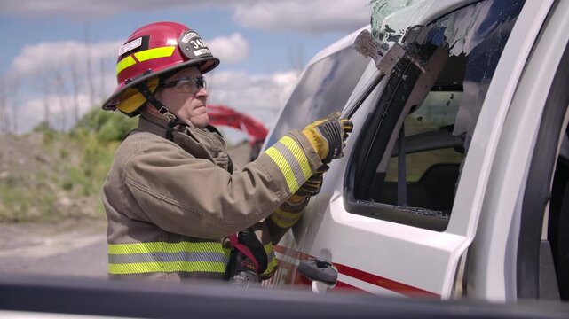Firefighters on the scene with a car crash performing a rescue