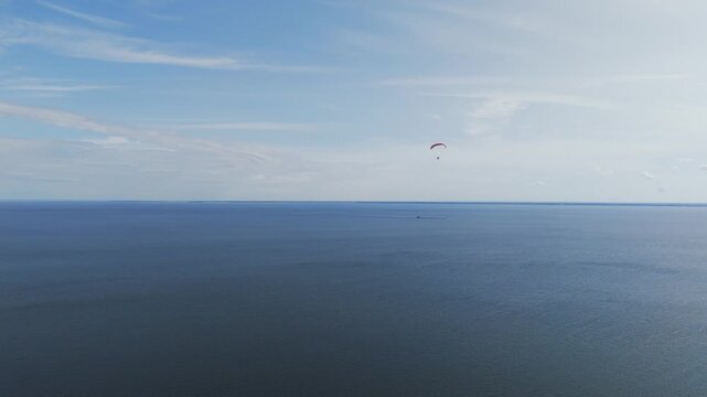 Paramotor flying over vast volga river expanse