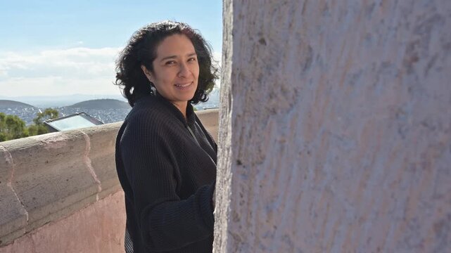 Peaceful Mature Woman Enjoying Sunny Day and Gentle Breeze at Lookout