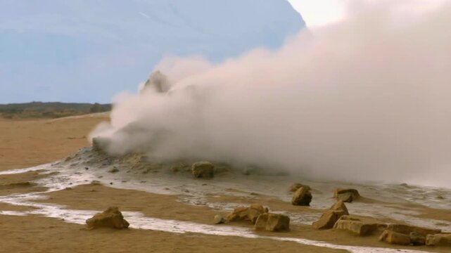 Hot steam rising from a volcanic fumarole in a geothermal area in Iceland