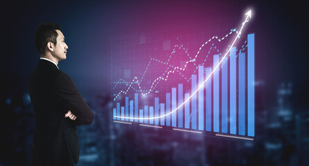 A businessman stands confidently, observing virtual financial graphs that showcase significant growth trends amidst a modern city backdrop, symbolizing success. Impute © InfiniteFlow